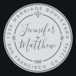 Sticker Rond Rustic Chic Mariage Retour Adresse Pastel Blue<br><div class="desc">Chic, moderne et simple mariage fait maison autocollant d'adresse de retour avec vos noms et adresse en noir élégant script calligraphie et typographie stylisée sur un arrière - plan bleu pastel, agrémenté de lauriers et autres détails décoratifs rustiques. Ajoutez simplement votre nom et votre adresse de monogramme conçus exclusivement pour...</div>