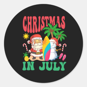 Sticker Rond Santa surfant sur la plage hawaïenne de Noël en ju