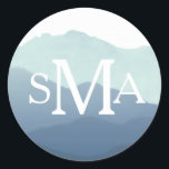 Sticker Rond Sceau de l'enveloppe du monogramme de montagne<br><div class="desc">Design de mariage élégant avec une aquarelle peinte à la main par Shelby Allison. Ce design est actuellement disponible en bleu,  marron,  vert et violet.</div>