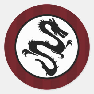 Sticker Rond Silhouette de dragon noir sur les rayures rouges