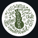 Sticker Rond Snowman Christmas Winter Wonderland typographie<br><div class="desc">Une composition de typographie festive de la citation de Noël manuscrite (Snow Chill, Jingle Bells, Cold Winter, White Christmas, Wonderland, Christmas Wish) encercle un doodle bonhomme de neige avec peu de coeurs et des flocons de neige. Parfait pour vous sceller les lettres et les Cartes de fin de année de...</div>