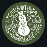 Sticker Rond Snowman Christmas Winter Wonderland typographie<br><div class="desc">Une composition de typographie festive de la citation de Noël manuscrite (Snow Chill, Jingle Bells, Cold Winter, White Christmas, Wonderland, Christmas Wish) encercle un doodle bonhomme de neige avec peu de coeurs et des flocons de neige. Parfait pour vous sceller les lettres et les Cartes de fin de année de...</div>