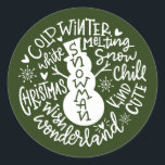 Sticker Rond Snowman Christmas Winter Wonderland typographie<br><div class="desc">Une composition de typographie festive de la citation de Noël manuscrite (Snow Chill, Jingle Bells, Cold Winter, White Christmas, Wonderland, Christmas Wish) encercle un doodle bonhomme de neige avec peu de coeurs et des flocons de neige. Parfait pour vous sceller les lettres et les Cartes de fin de année de...</div>