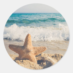 Sticker Rond Starfish sur une plage de sable Photo