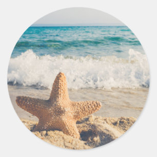 Sticker Rond Starfish sur une plage de sable Photo