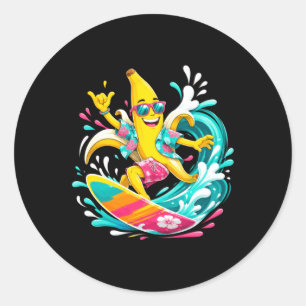Sticker Rond Surfeur de banane tropical chevauchant les vagues