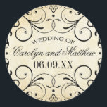 Sticker Rond Vintage Rustic Black Flourish Mariage<br><div class="desc">Des tourbillons et des fioritures décoratifs noir encadrent cette élégante typographie vintage mariage faveur autocollant design. L'arrière - plan d'ivoire rustique est imprimé avec une texture de papier parchemin vieilli. Personnalisez le texte personnalisé avec un monogramme des noms de mariée et de mariée et la date du mariage.</div>