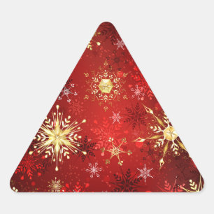 Sticker Triangulaire Flocons de neige dorés de Noël sur fond rouge