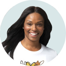 A woman against a pastel green background.