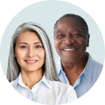 A grandmother and grandfather against a pastel green background.