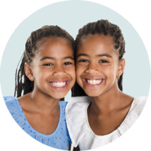 Two children against a pastel green background.