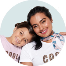 A mom and daughter against a pastel green background.