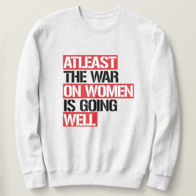 Sweatshirt Au moins, la guerre contre les femmes se porte bie (Design devant)