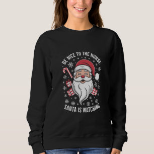 Sweatshirt Soyez gentil avec l'infirmière Santa regarde Noël