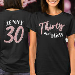 T-shirt 30e anniversaire trente flirty rose nom argent<br><div class="desc">Trente et flirté, 30ème anniversaire style de parties scintillant effet trente texte de script dans les teintes rose rose et argent avec le texte sur t-shirt couleur foncé et un numéro 30 au verso et votre nom. Personnalisez cette chemise de 30e anniversaire avec votre message et votre nom. D'autres années...</div>
