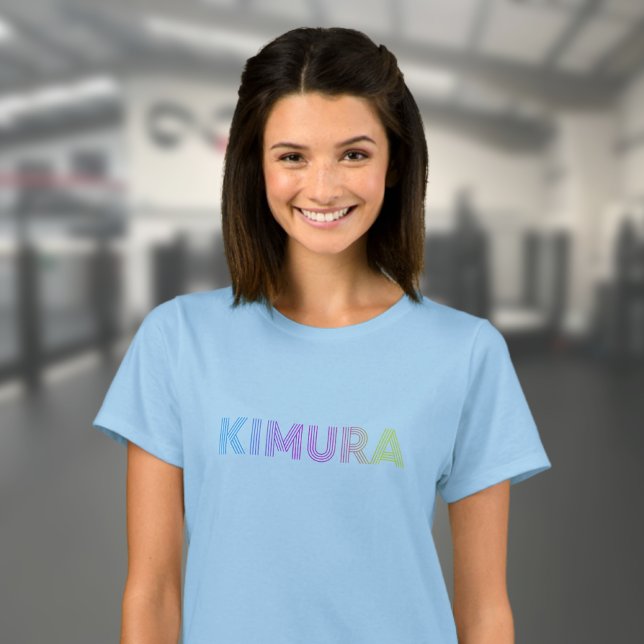 T-shirt BJJ Kimura Brésilienne Jiu Jitsu Blue Femmes (Blue BJJ Kimura T-shirt worn by a female model in the gym.)