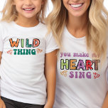 T-Shirt Chose sauvage Vous Faites Chanter mon Coeur Super<br><div class="desc">T-shirt enfant 'wild thing' avec la version t-shirt maman 'you make my heart sing' assortie disponible. Ce design de typographie coloré présente des lettres modernes et courbes et des imprimés dessinés dans des couleurs vives, décorés de coeurs d'amour. Citation amusante, répartis sur la tenue mère et enfant qui aussi fonctionne...</div>