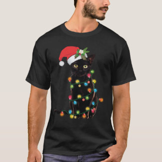 T-shirt Le Chat Noir De Père Noël Enveloppé Dans Les Lumiè
