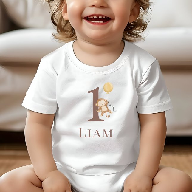 T-shirt Pour Bébé Numéro d'anniversaire du petit singe (Toddler wearing a white T-Shirt with the number 1 and a monkey holding a balloon.)