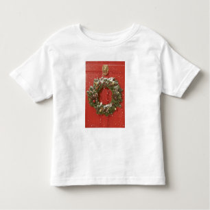 T-shirt Pour Les Tous Petits Guirlande de Noël accrochant sur une porte