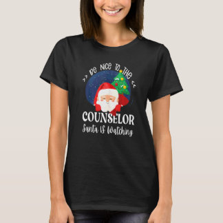 T-shirt Soyez gentil avec le conseiller Santa regarde l'éc