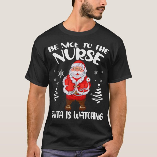 T-shirt Soyez gentil avec l'infirmière Santa regarde Noël  (Devant)