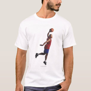 T-shirt un jeune joueur de basket de mâle adulte vole
