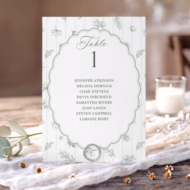 Tableau de placement de mariage ovale vert sauge v (Sage green French floral wedding seating chart card with oval scalloped frame and guest names.)