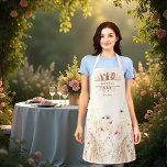 Tablier Aquarelle crème beige fleur sauvage rose boho<br><div class="desc">Un tablier de style boho. Arrière - plan beige crème. Décoré de fleurs sauvages roses aquarelles et d'abeilles. Personnalisez et ajoutez votre nom et un texte. Ustensiles de cuisine encadrant le nom.</div>