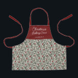 Tablier Équipement de cuisson de Noël à la florale pour en<br><div class="desc">Ce magnifique tablier de Noël est orné d'un motif floral et verdoyant dessiné à la main dans des couleurs classiques et traditionnelles de Noël, vert foncé, rouge bordeaux, et ivoire sur un arrière - plan beige de sable. La typographie de script est simple : "Christmas Baking Crew", et un modèle...</div>