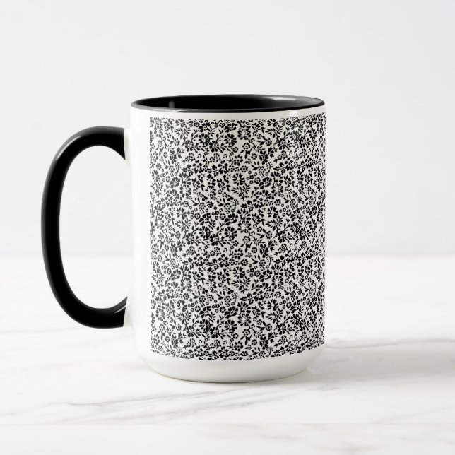 Tasse blanche et noire à fleurs. (Gauche)