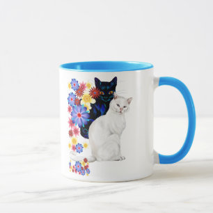 Tasses noires et blanches de minous de jardin