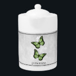Teapot floral papillon vert<br><div class="desc">Savourez votre thé avec une théière personnalisée à base de papillon vert. Le design de la théière comprend une paire de papillons vibrants reposant sur une vigne florale blanche contre un arrière - plan gris clair. Autres cadeaux disponibles avec ce design ainsi qu'une variété de couleurs.</div>