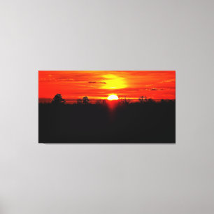 Toile Coucher de soleil vibrant sur l'horizon de la forê