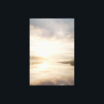 Toile Misty Lake Sunrise Golden Reflection<br><div class="desc">Soft golden sunlight pierces through thick morning mist over a calm lake, creating a luminous path of reflection across the water. Tall reeds line the shore while distant trees fade into the haze, and the sky blends warm peach and rose tones into pale blue-gray. The composition radiates profound stillness, gentle...</div>