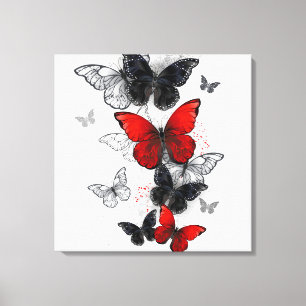 Toile Papillons noirs et rouges volants