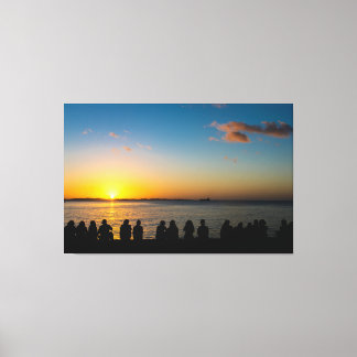Toile Silhouette of People Watching Golden Sunset over O