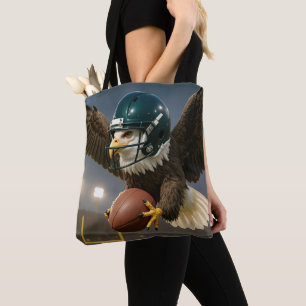 Tote Bag Aigle avec un ballon de football dans un stade de