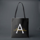 Tote Bag Black Name Gold Girl Script Monogramme moderne<br><div class="desc">Black and Gold Elegant Ajoutez votre propre nom Monogram Book Bag. Ce sac de livre peut être customisé pour inclure votre nom initial et prénom et donné comme cadeau pour Noël,  Sweet 16 Anniversaire,  Fête des mariées ou Mariage.</div>