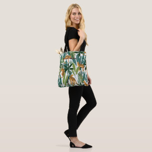Tote Bag Brown leopard in the tropical lush jungle leaves