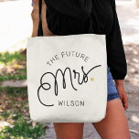 Tote Bag Futur MRS Bride Modern Script Gold Nom<br><div class="desc">Ce sac fourre-tout moderne avec un design de calligraphie décontracté chic minimaliste lisant THE FUTURE MRS. ainsi que votre nom personnalisé dispose de lignes propres pour créer un aspect élégant et sophistiqué. Le style sobre et le petit détail imprimé du coeur d'or ajoutent une touche de sophistication à votre look...</div>