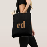 Tote Bag Initiales en or noir monogramme élégant moderne<br><div class="desc">Un arrière - plan noir classique et chic. Personnalisez et ajoutez vos initiales monographiques écrites avec des lettres en bloc dorées. Moderne,  tendance et simple.</div>