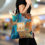Tote Bag Marbre aquarelle monogramme or turquoise & orange<br><div class="desc">Un carré brillant et imitation doré avec une typographie script monogramme initial recouvre un arrière - plan d'aquarelle bleu turquoise et jaune orangé, veiné or, riche, sur ce sac fourre-tout élégant, tendance, girly, moderne, monogramed. Fait une déclaration amusante et élégante chaque fois que vous l'utilisez. Un grand cadeau pour un...</div>