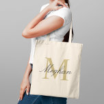 Tote Bag Modern Elegant Gold Black Personalized Monogram<br><div class="desc">Modern and elegant tote bag features a simple and minimal custom gold and black (colors can be modified) personalized monogram design that can be personalized with an initial and name in script. Perfect gift for your wedding party - maid of honor, bridesmaids, mothers of the bride and groom, and flower...</div>