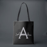 Tote Bag Noir Argent moderne Script Girl Monogramme Nom<br><div class="desc">Black and Silver Elegant Ajoutez Votre Propre Nom Monogram Book Bag. Ce sac de livre peut être customisé pour inclure votre nom initial et prénom et donné comme cadeau pour Noël,  Sweet 16 Anniversaire,  Fête des mariées ou Mariage.</div>