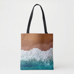 Tote Bag Ocean wave on a sandy beach, background top view