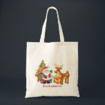 Tote Bag Santa and Reindeer par Christmas Tree with Present<br><div class="desc">Une jolie illustration avec l'esprit de fête. Le Père Noël portant son sac cadeau et saluant. Son ami renne à ses côtés, suspendu par un sapin décoré, avec des cadeaux tout autour. Placez-vous sur un arrière - plan rouge avec des cercles fantaisistes. Design festif et gai. Personnalisez avec un nom...</div>