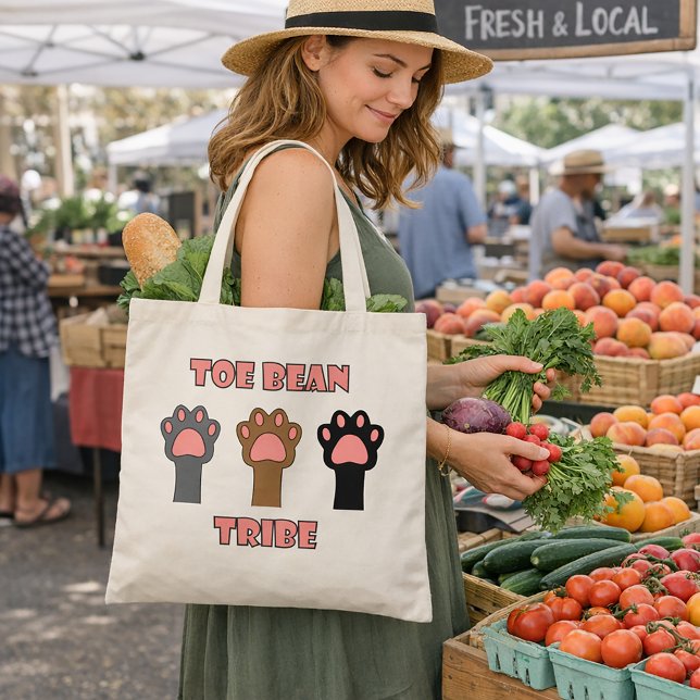 Tote Bag Toe Bean Tribe Cute Cat Paws (A tote bag with three cat paws and the words toe bean tribe in pink with a gray outline.)