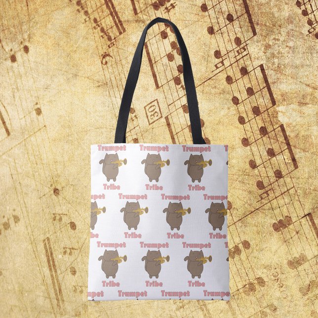 Tote Bag Trumpet Tribe Brown Cat Pattern (A tote bag with a pattern of a cat playing the trumpet and the words trumpet tribe in pink.)