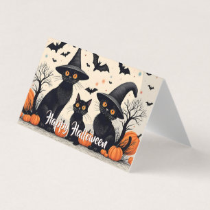 Trois chats noirs avec des chapeaux à Halloween